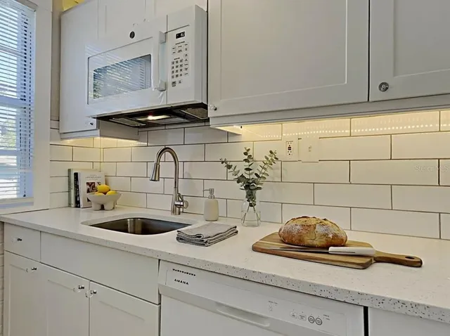 a kitchen with a sink and cabinets