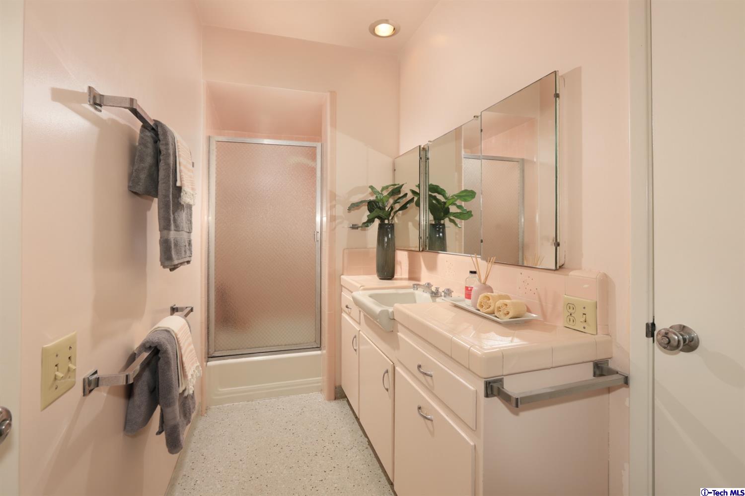 1350 Selvas Place Glendale, CA 91208 - Photo 11 of 30 a bathroom with a double vanity sink a mirror and shower