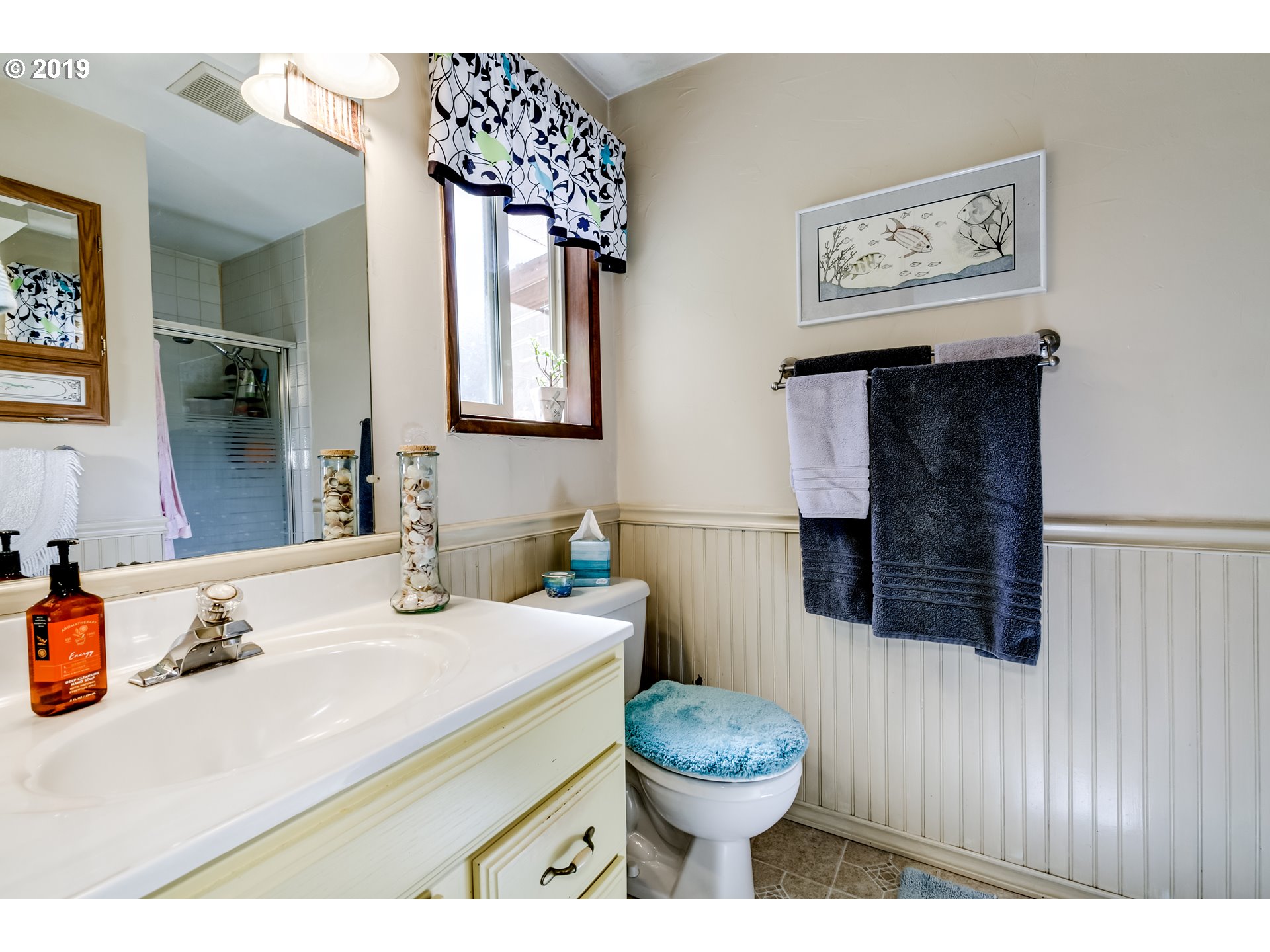 537 66th Street Springfield, OR 97478 - Photo 17 of 32 a bathroom with a sink a toilet and a mirror