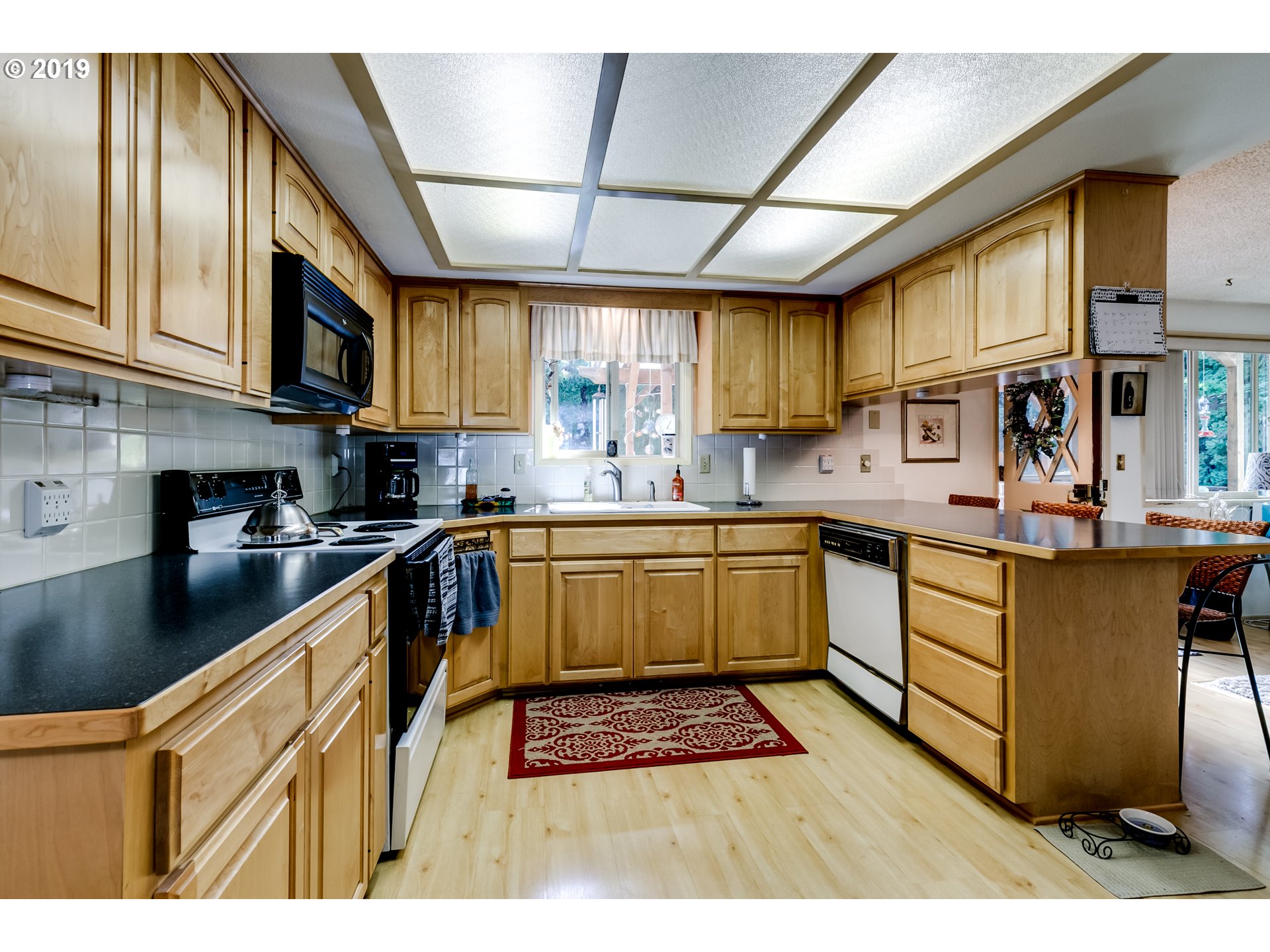 537 66th Street Springfield, OR 97478 - Photo 18 of 32 a kitchen with stainless steel appliances granite countertop a sink a stove and cabinets
