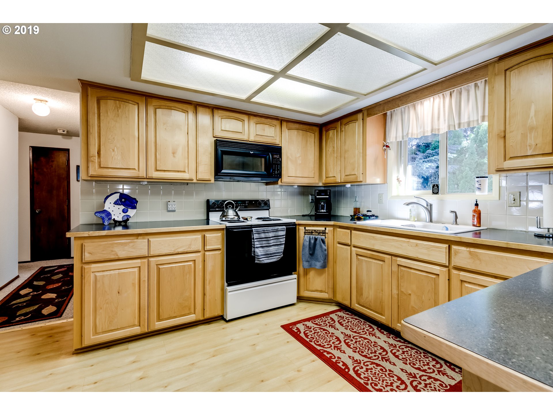 537 66th Street Springfield, OR 97478 - Photo 19 of 32 a kitchen with stainless steel appliances granite countertop a stove sink and cabinets