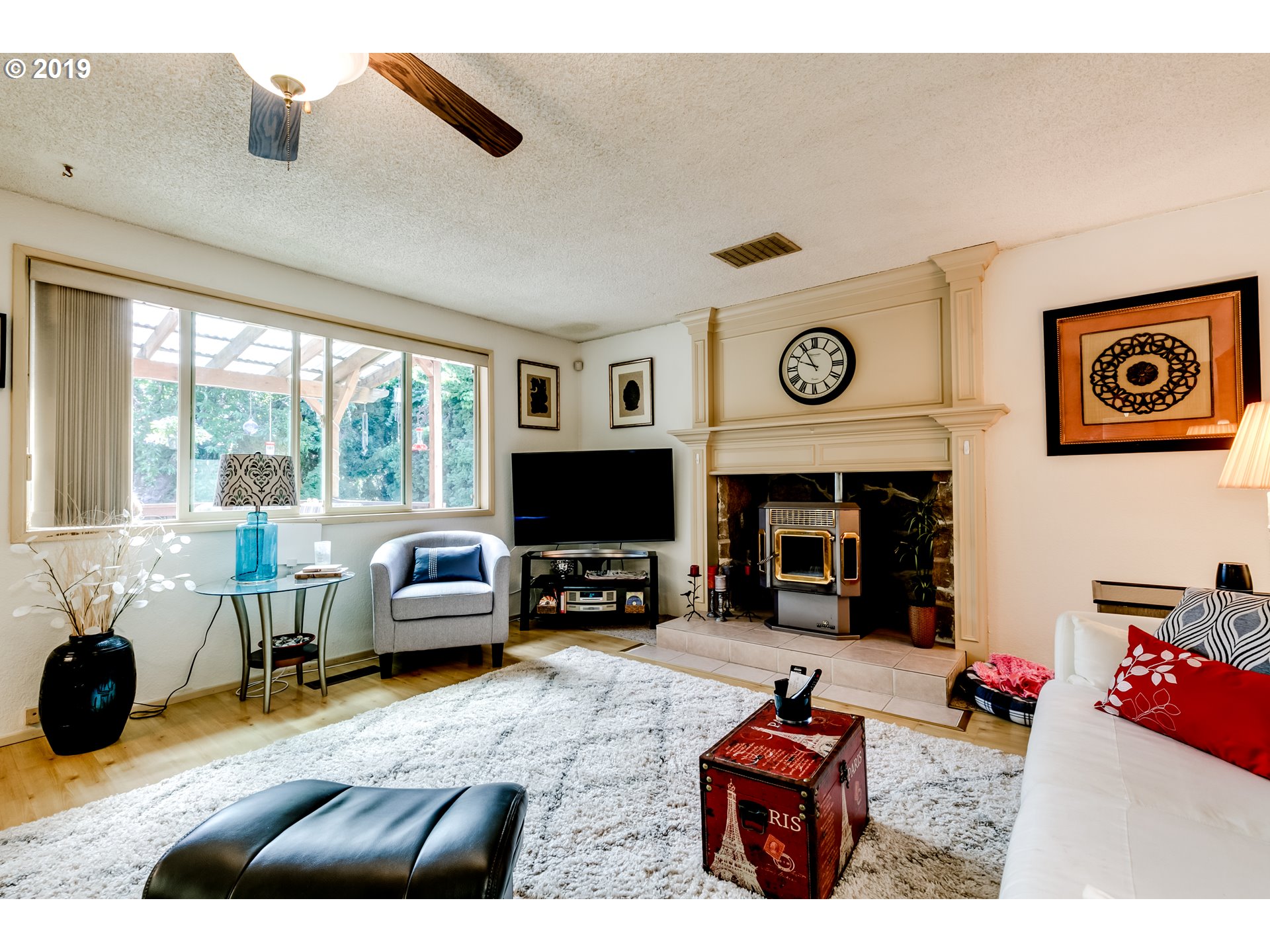 537 66th Street Springfield, OR 97478 - Photo 22 of 32 a living room with furniture a fireplace and a flat screen tv