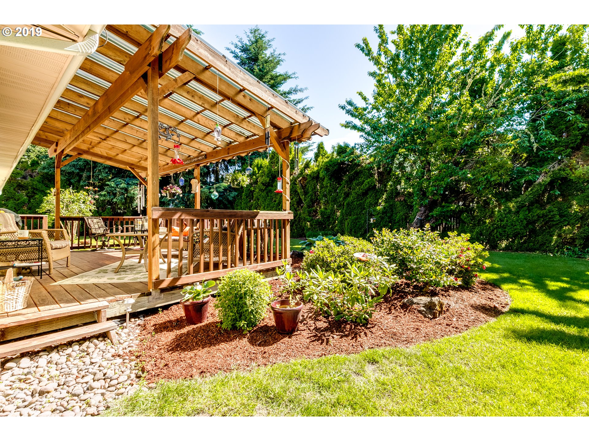 537 66th Street Springfield, OR 97478 - Photo 28 of 32 a view of a patio with table and chairs under an umbrella