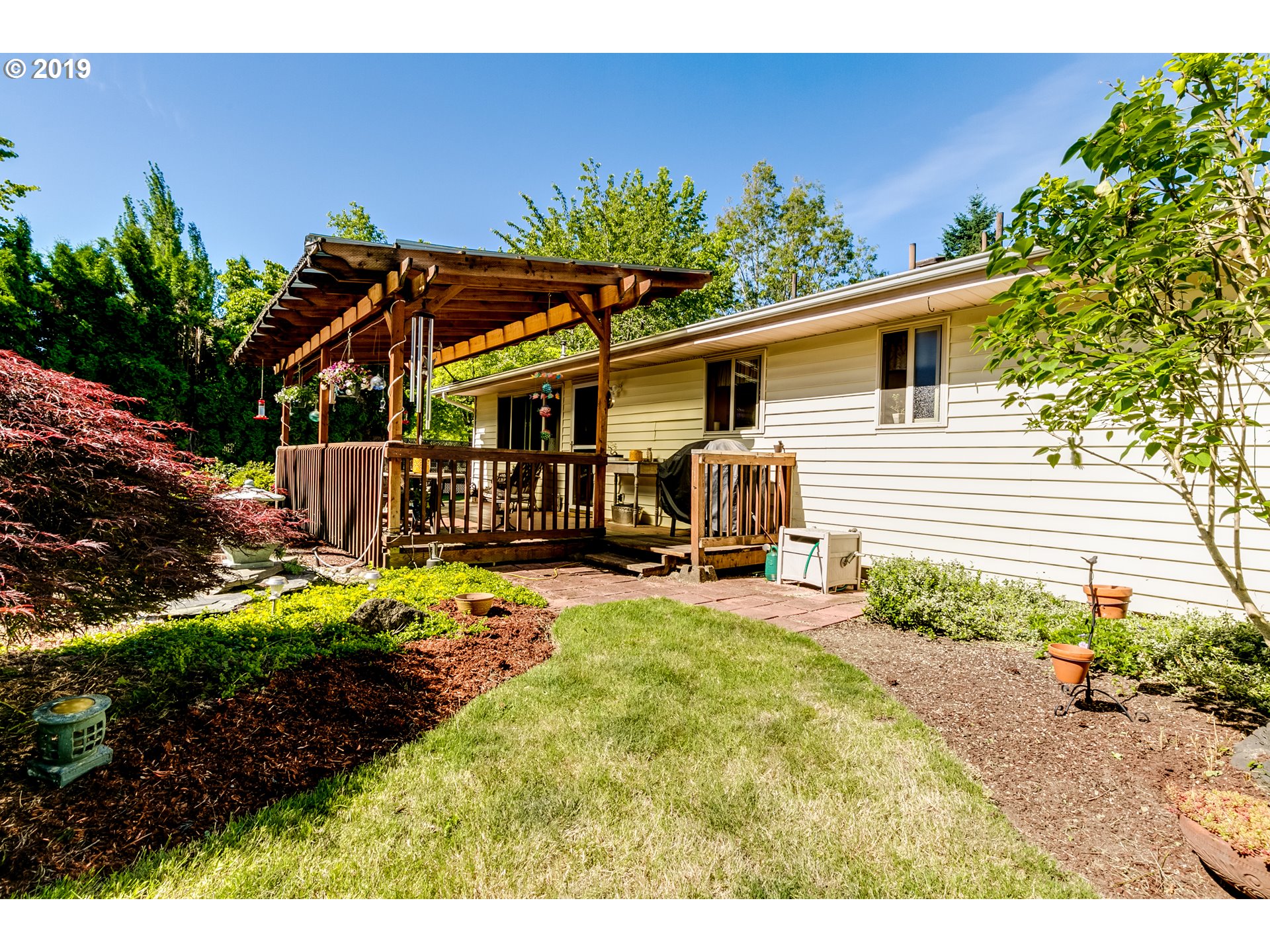 537 66th Street Springfield, OR 97478 - Photo 31 of 32 a view of a house with backyard and sitting area