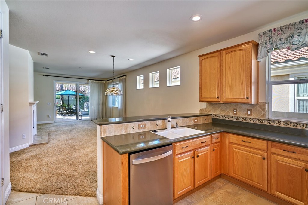 1143 Saguara Road Beaumont, CA 92223 - Photo 41 of 66 a kitchen that has a sink and a stove in it