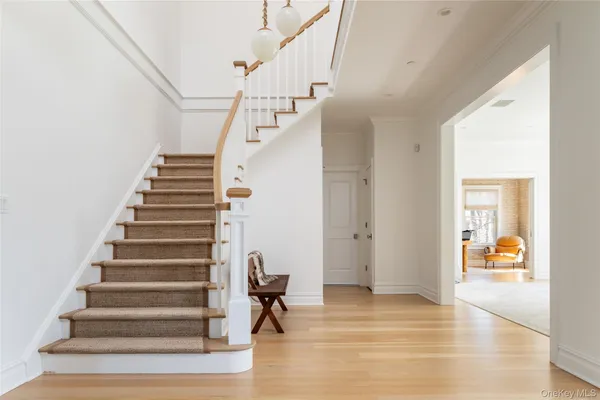 a view of entryway and hall with wooden floor