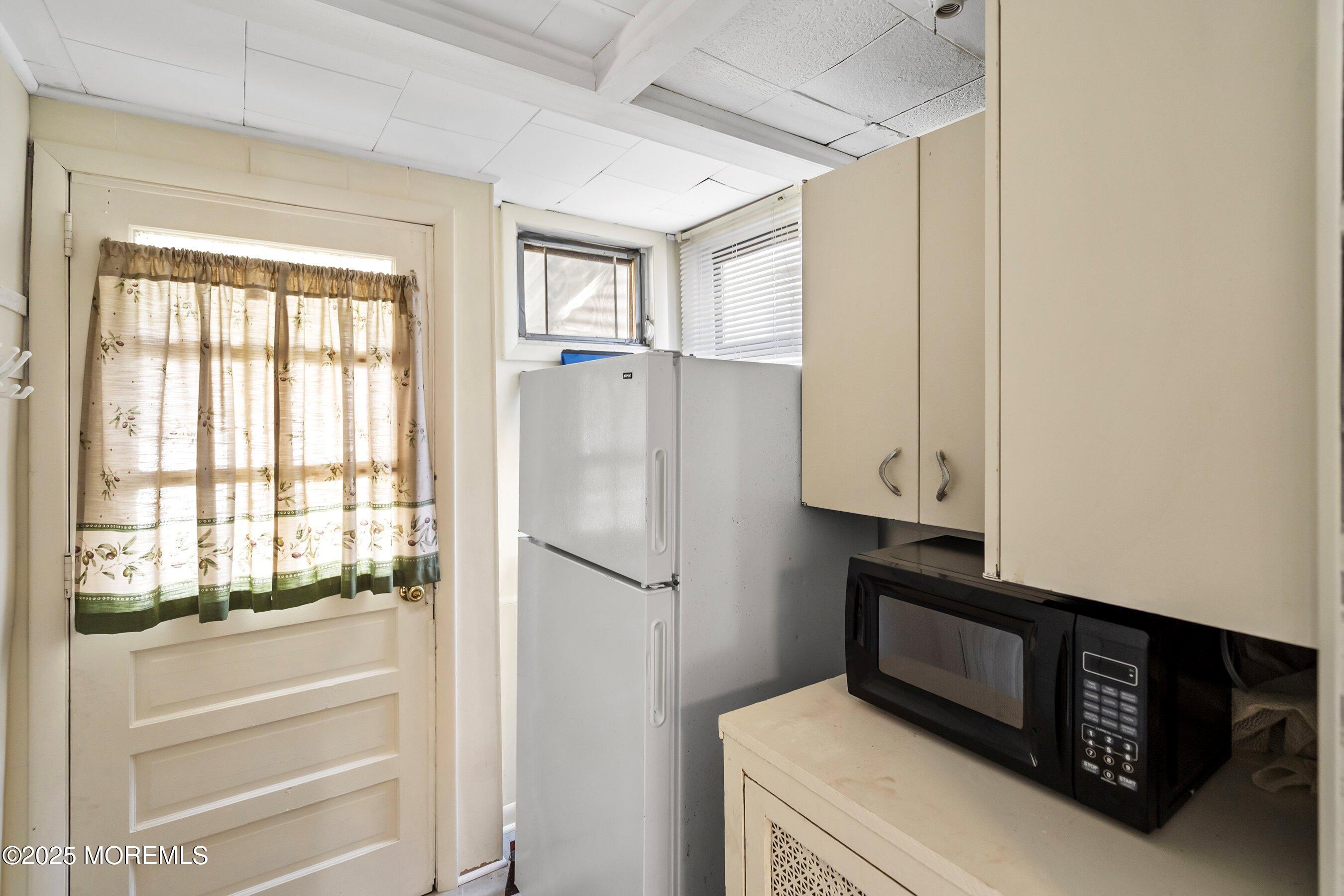 204 19th Avenue Belmar, NJ 07719 - Photo 11 of 24 a kitchen with a refrigerator and window
