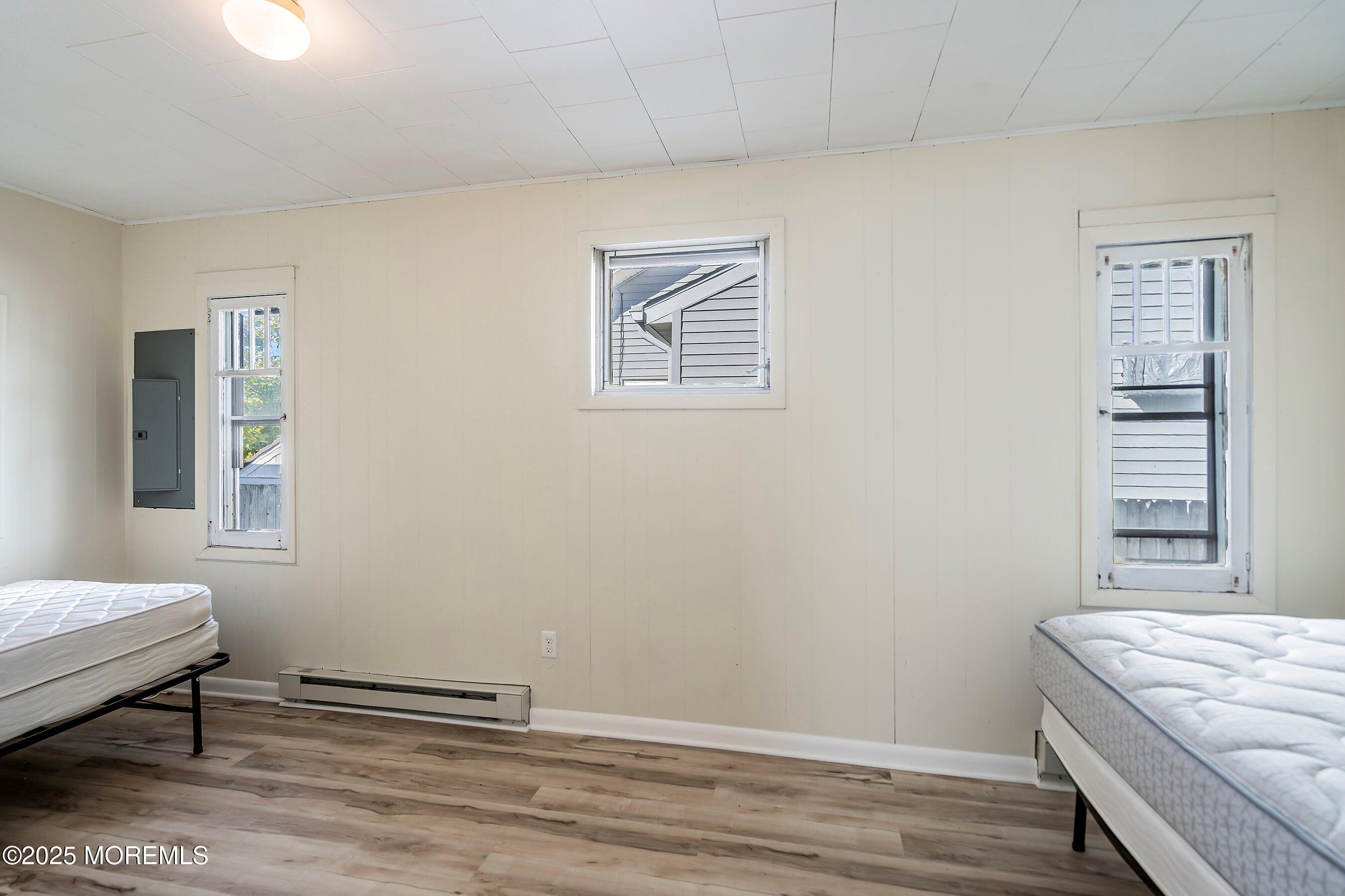 204 19th Avenue Belmar, NJ 07719 - Photo 12 of 24 a bedroom with a bed and a window