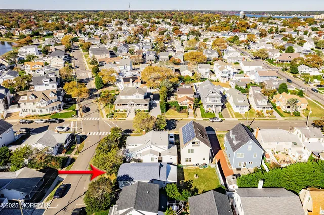 an aerial view of a house with a yard