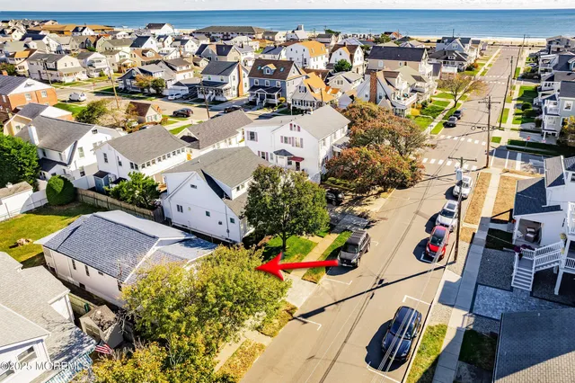 an aerial view of residential house with outdoor space and parking
