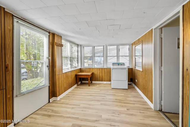 a spacious bedroom with a large bed and large windows