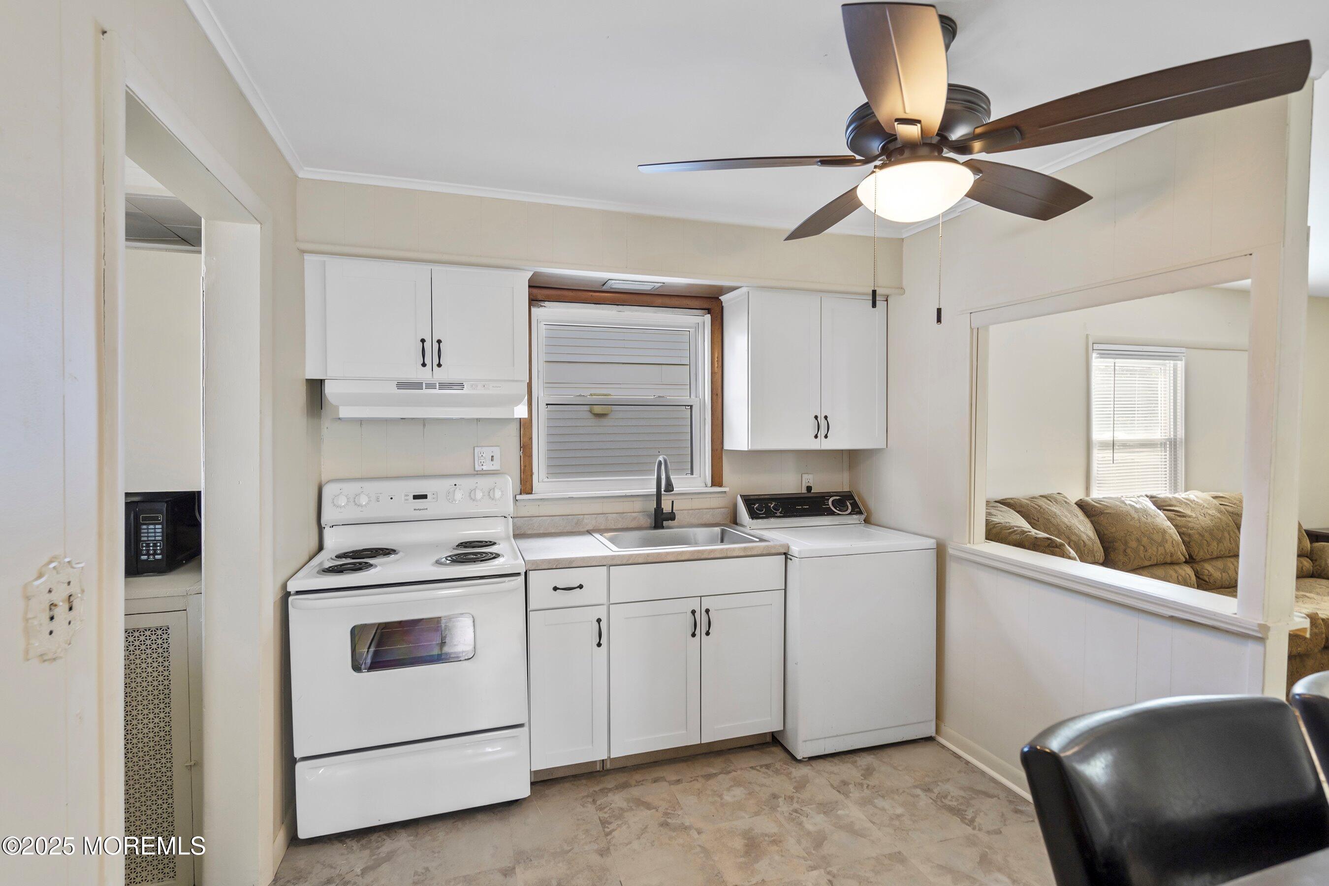 204 19th Avenue Belmar, NJ 07719 - Photo 9 of 24 a kitchen with a stove cabinets and white appliances