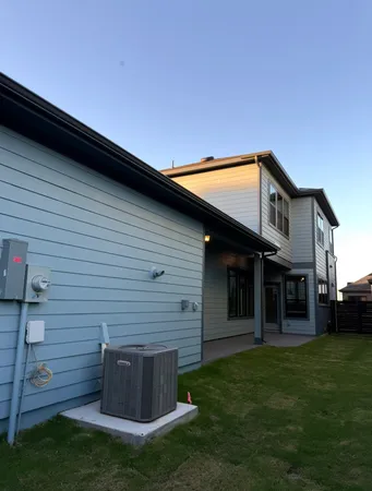 a view of a house with a backyard