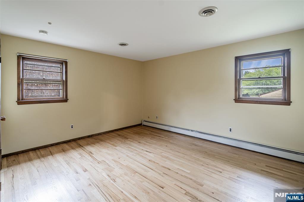 5-03 River Road Fair Lawn, NJ 07410 - Photo 11 of 21 a view of an empty room with wooden floor and a window