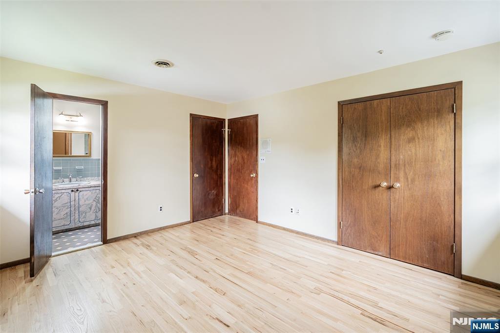 5-03 River Road Fair Lawn, NJ 07410 - Photo 12 of 21 a view of an empty room with wooden floor and closet