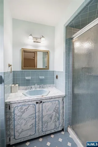 a bathroom with a sink a vanity and a mirror