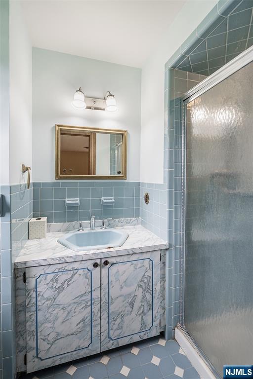 5-03 River Road Fair Lawn, NJ 07410 - Photo 13 of 21 a bathroom with a sink a vanity and a mirror