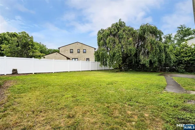 a view of a garden with large trees