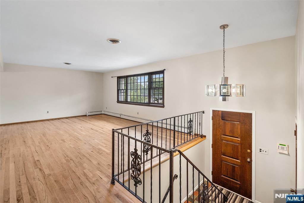5-03 River Road Fair Lawn, NJ 07410 - Photo 3 of 21 a view of a room with wooden floor and white walls