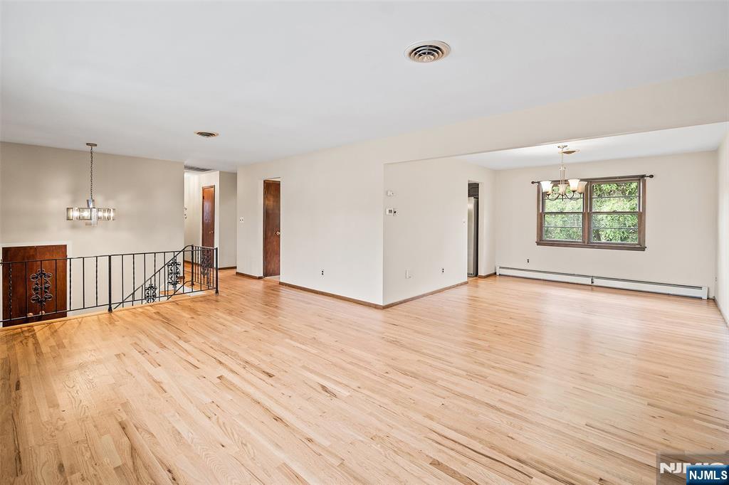 5-03 River Road Fair Lawn, NJ 07410 - Photo 4 of 21 a view of an empty room with window and wooden floor