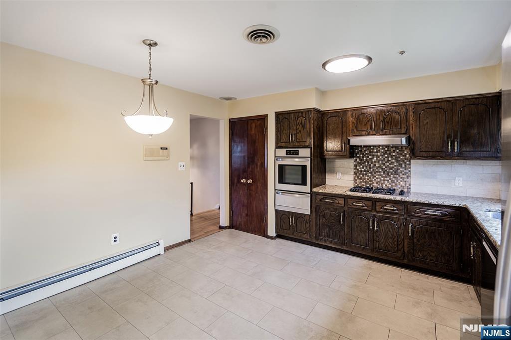 5-03 River Road Fair Lawn, NJ 07410 - Photo 5 of 21 a kitchen with stainless steel appliances granite countertop a refrigerator and a sink