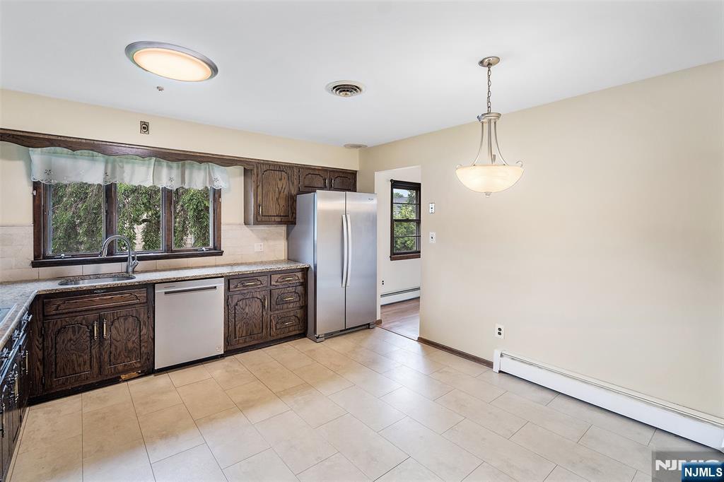 5-03 River Road Fair Lawn, NJ 07410 - Photo 6 of 21 a kitchen with stainless steel appliances a refrigerator and a sink