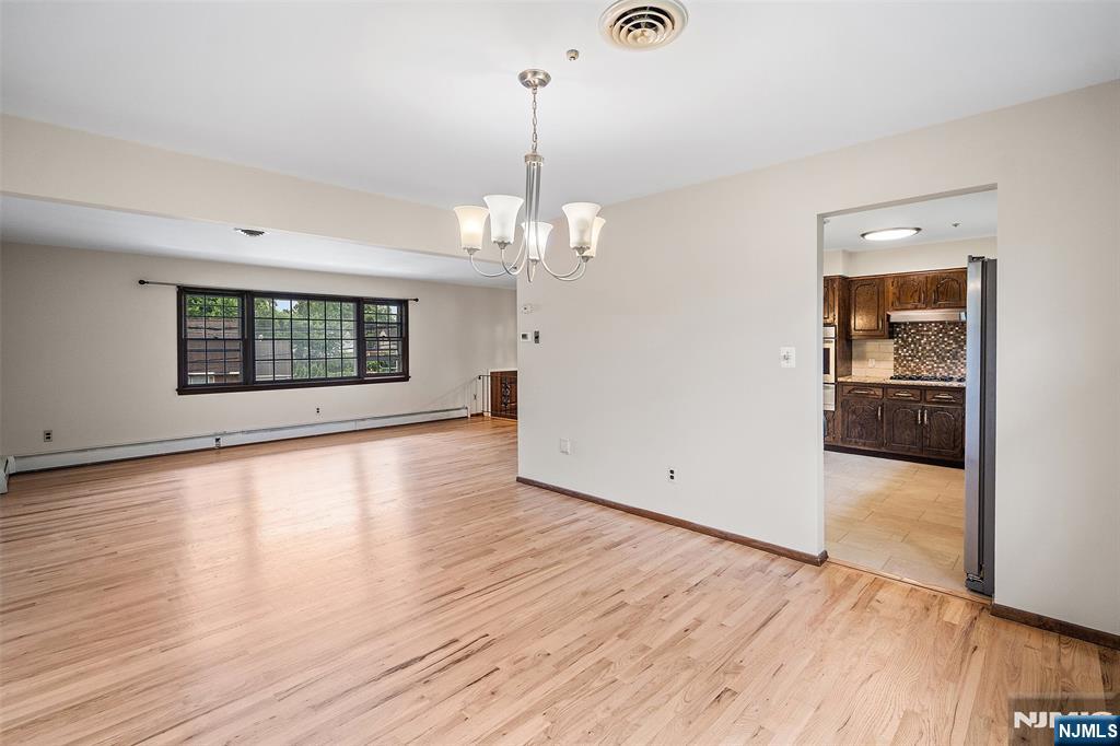 5-03 River Road Fair Lawn, NJ 07410 - Photo 8 of 21 an empty room with wooden floor and windows