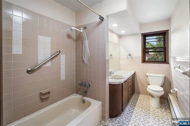 a bathroom with a sink toilet a shower and a mirror