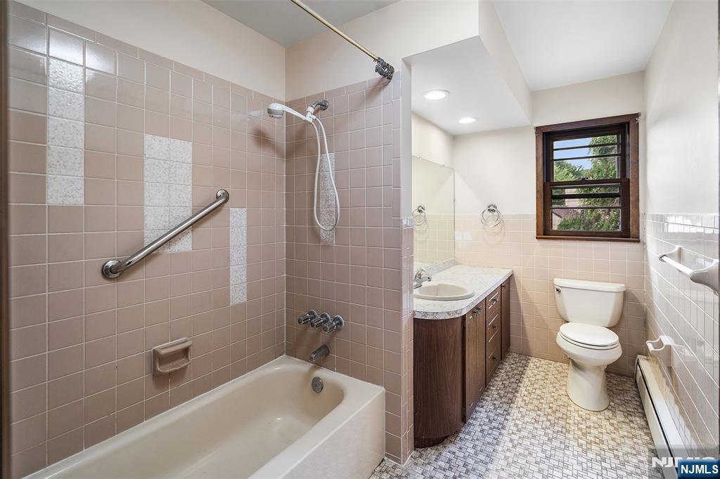 5-03 River Road Fair Lawn, NJ 07410 - Photo 9 of 21 a bathroom with a sink toilet a shower and a mirror