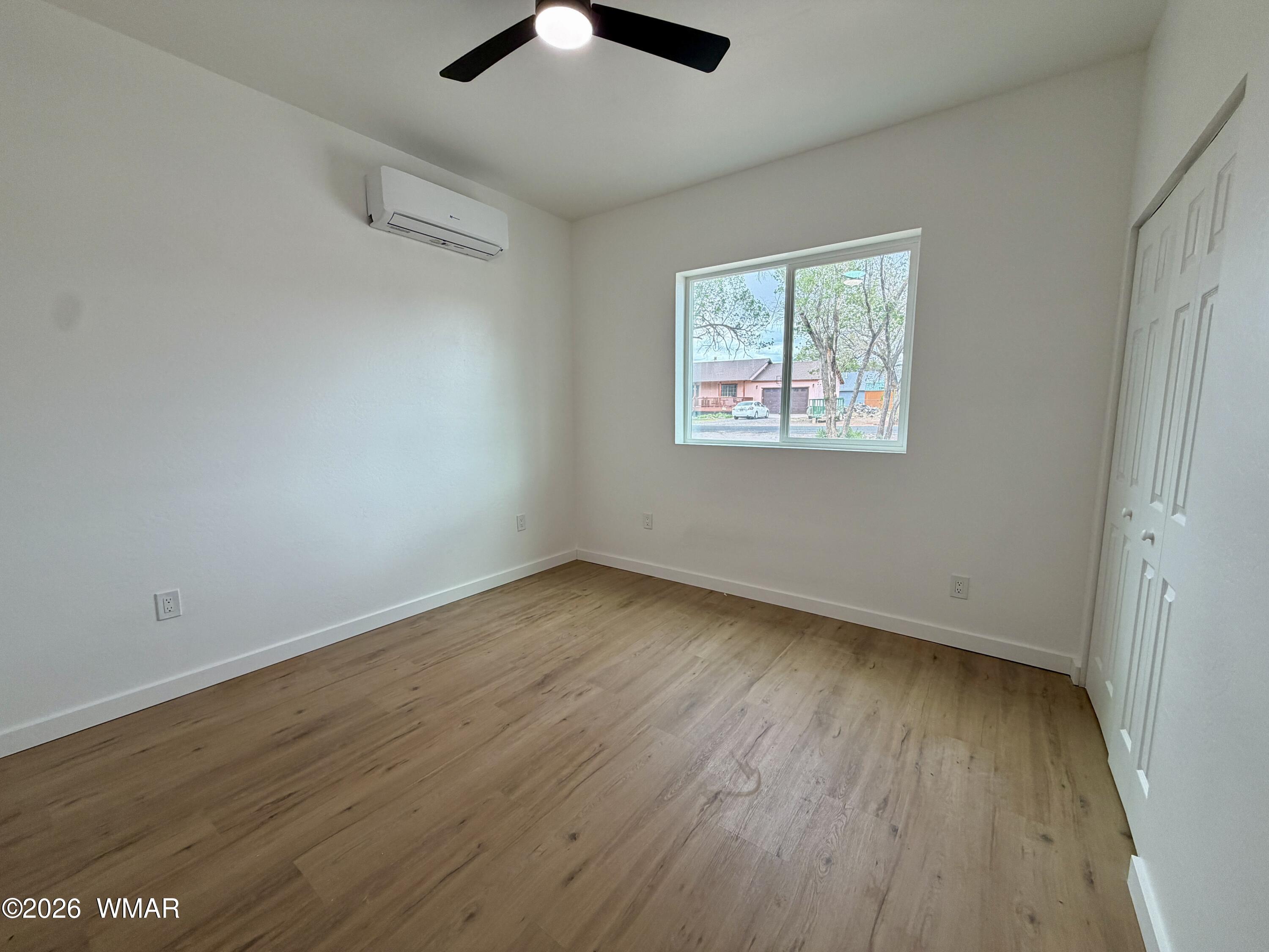 731 Tori Circle Springerville, AZ 85938 - Photo 13 of 19 an empty room with wooden floor and windows