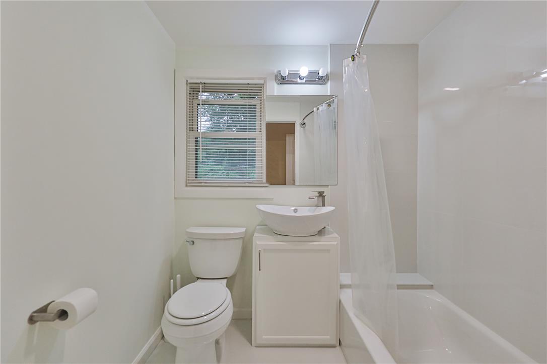 5599 Minks Pond Road Bushkill, PA 18324 - Photo 22 of 64 A well-appointed bath with a convenient tub, toilet, and sink, perfect for daily routines.