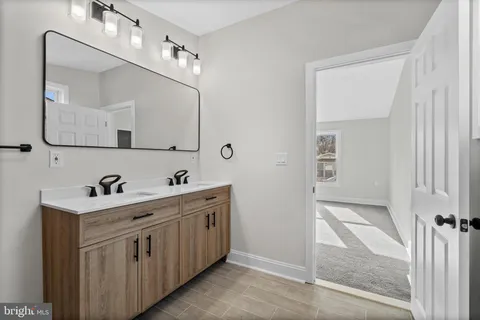 a bathroom with a sink a toilet and mirror