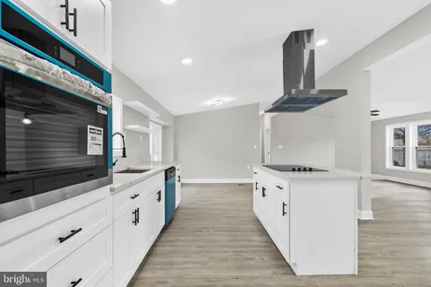 a kitchen with stainless steel appliances a sink and cabinets