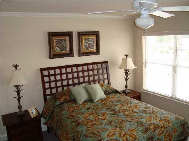 21 South Sand Palm Road, Unit 20 Freeport, FL 32439 - Photo 8 of 17 a bed sitting in a bedroom next to a window