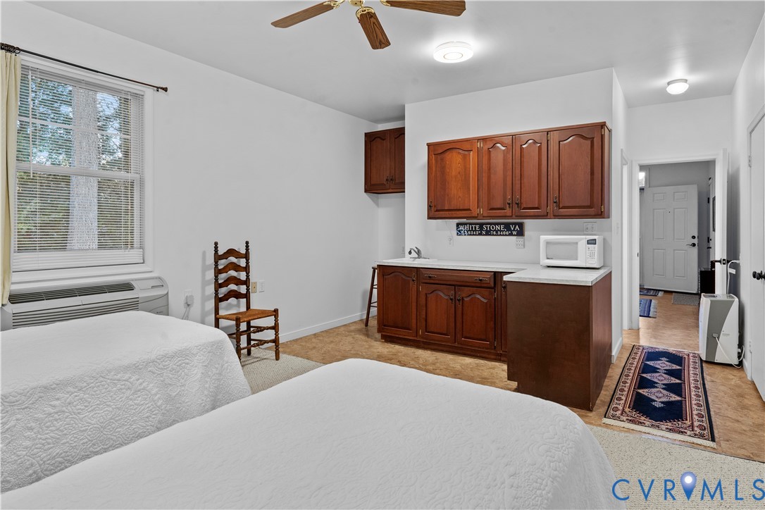 2515 Fleet's Bay Road White Stone, VA 22578 - Photo 59 of 74 a bedroom with a bed a flat screen tv and a couch