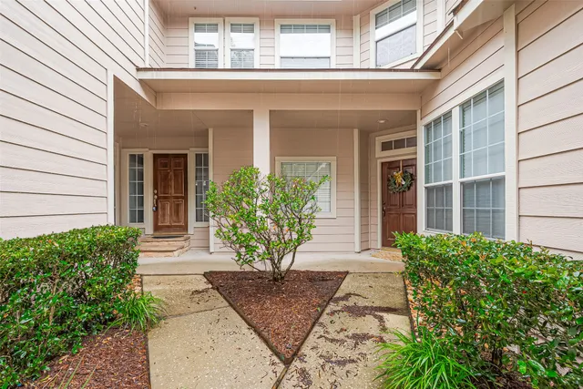 a view of a house with potted plants