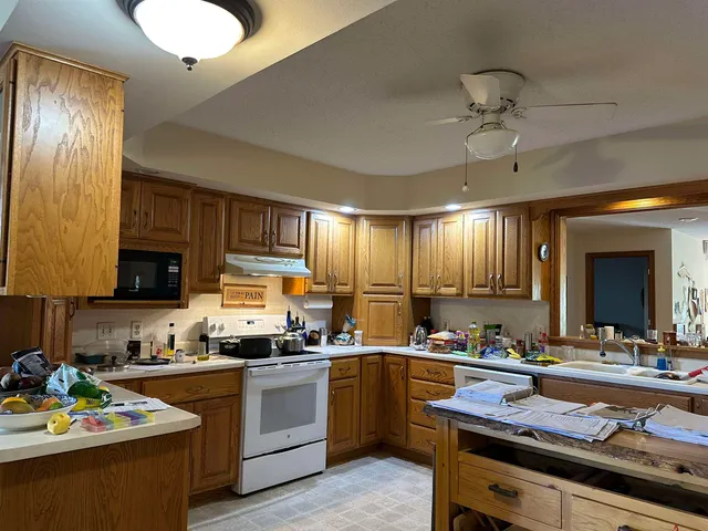 a kitchen with a sink stove and cabinets