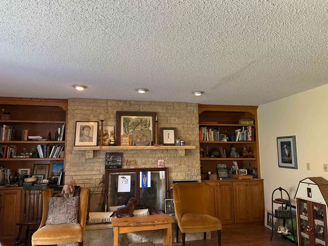 a living room with furniture and a book shelf