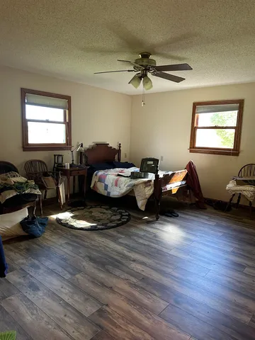 a living room with furniture window and wooden floor