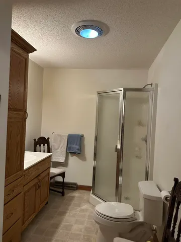a bathroom with a double vanity sink toilet and shower