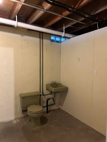 a bathroom with a toilet a sink and shower