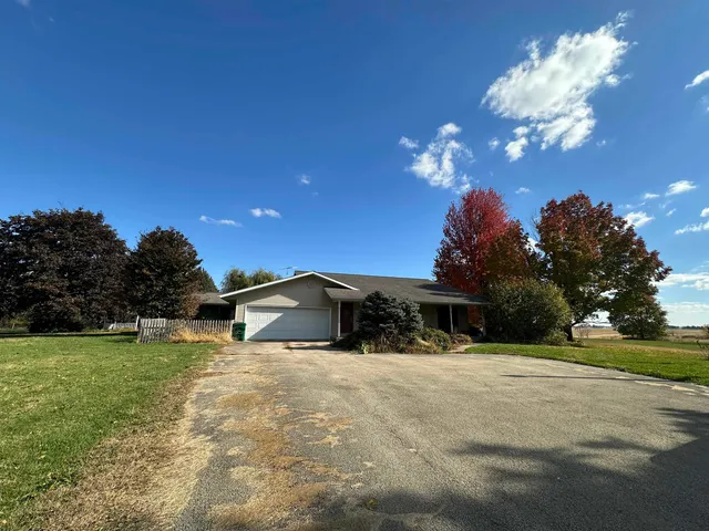 a view of a house with a yard yard and a garage