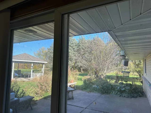 a view of a glass door with a yard