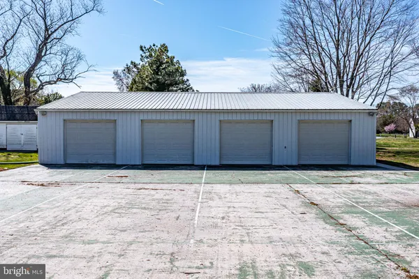 a view of a hallway with wooden floor and stairs