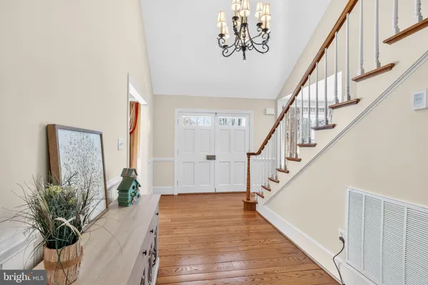 a kitchen with stainless steel appliances kitchen island granite countertop a table chairs sink and cabinets