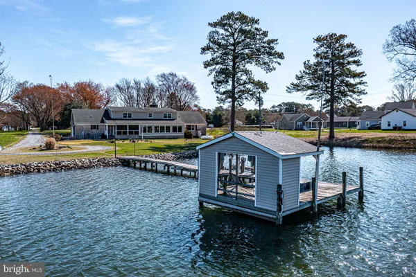 a view of a house with garden and lake view