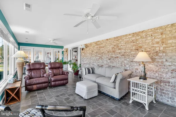 a living room with furniture a fireplace and a window