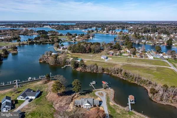 a kitchen with stainless steel appliances kitchen island granite countertop a table chairs and a refrigerator