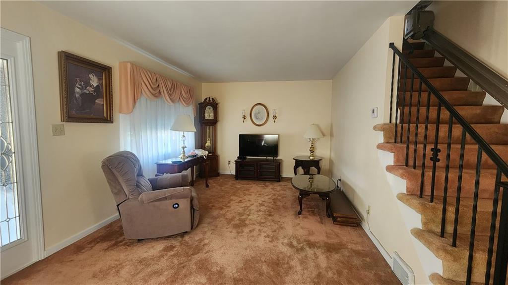 525 Burns Street Vandergrift, PA 15690 - Photo 4 of 25 a living room with furniture and a fireplace