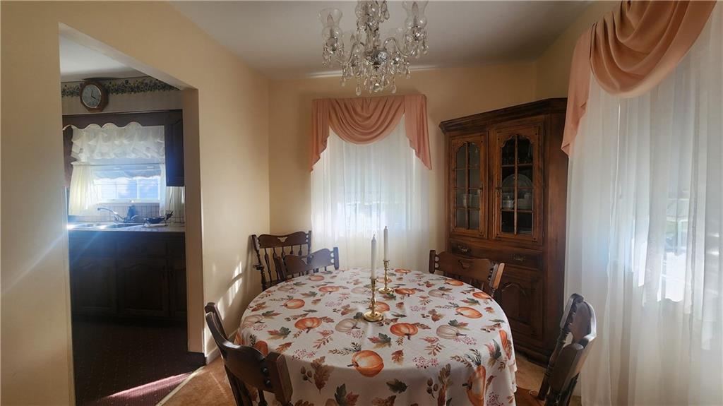 525 Burns Street Vandergrift, PA 15690 - Photo 6 of 25 a bedroom with a bed and a chandelier